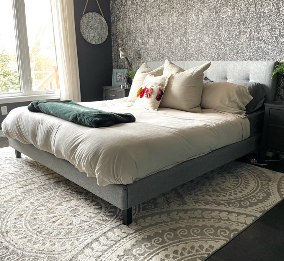 A modern and inviting bedroom with cozy grey accents, complete with the grey Endy Upholstered Bed.