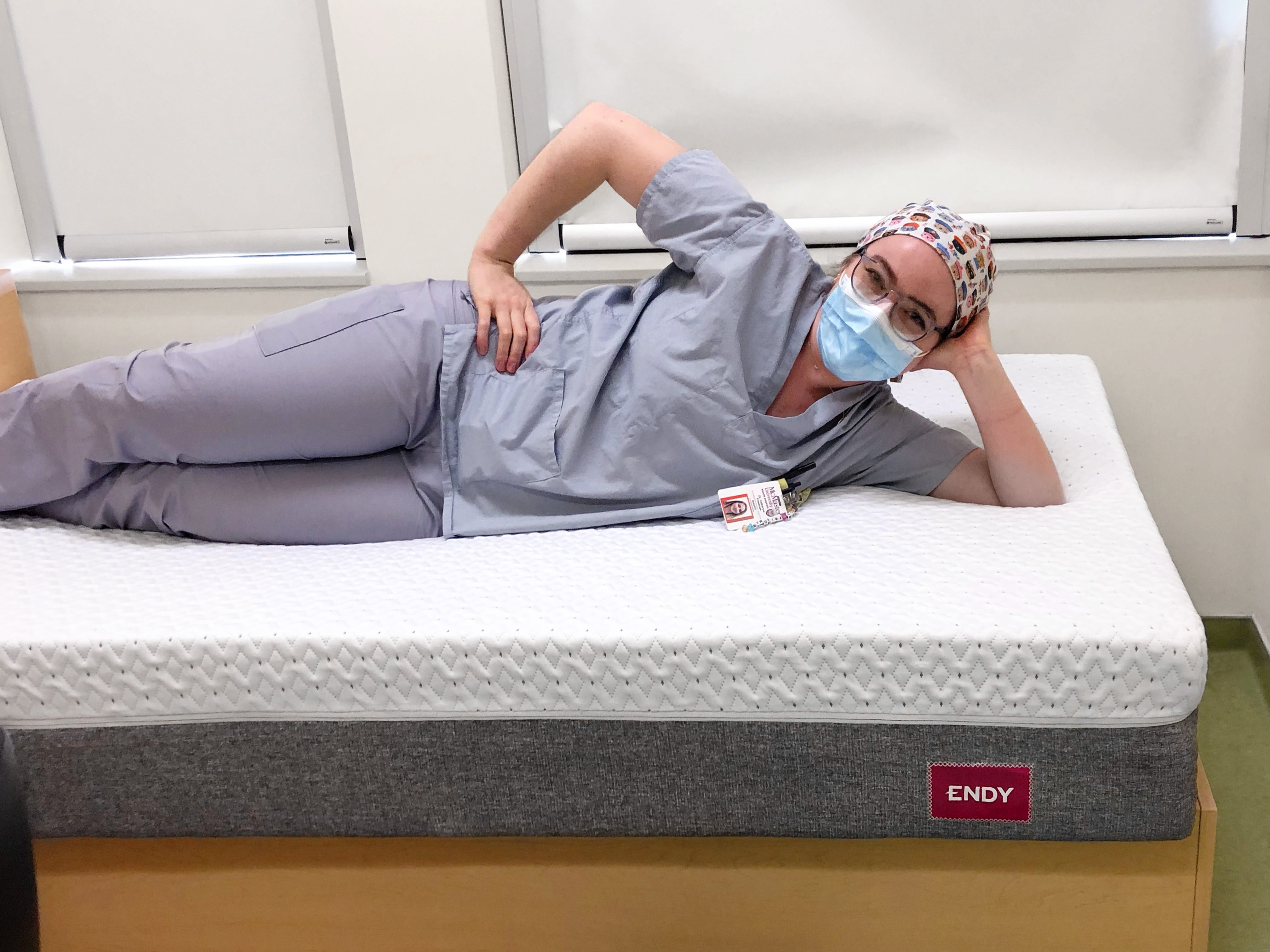 A healthcare worker from St.Joseph Healthcare Hamilton lounges comfortably on a brand new Endy Mattress.